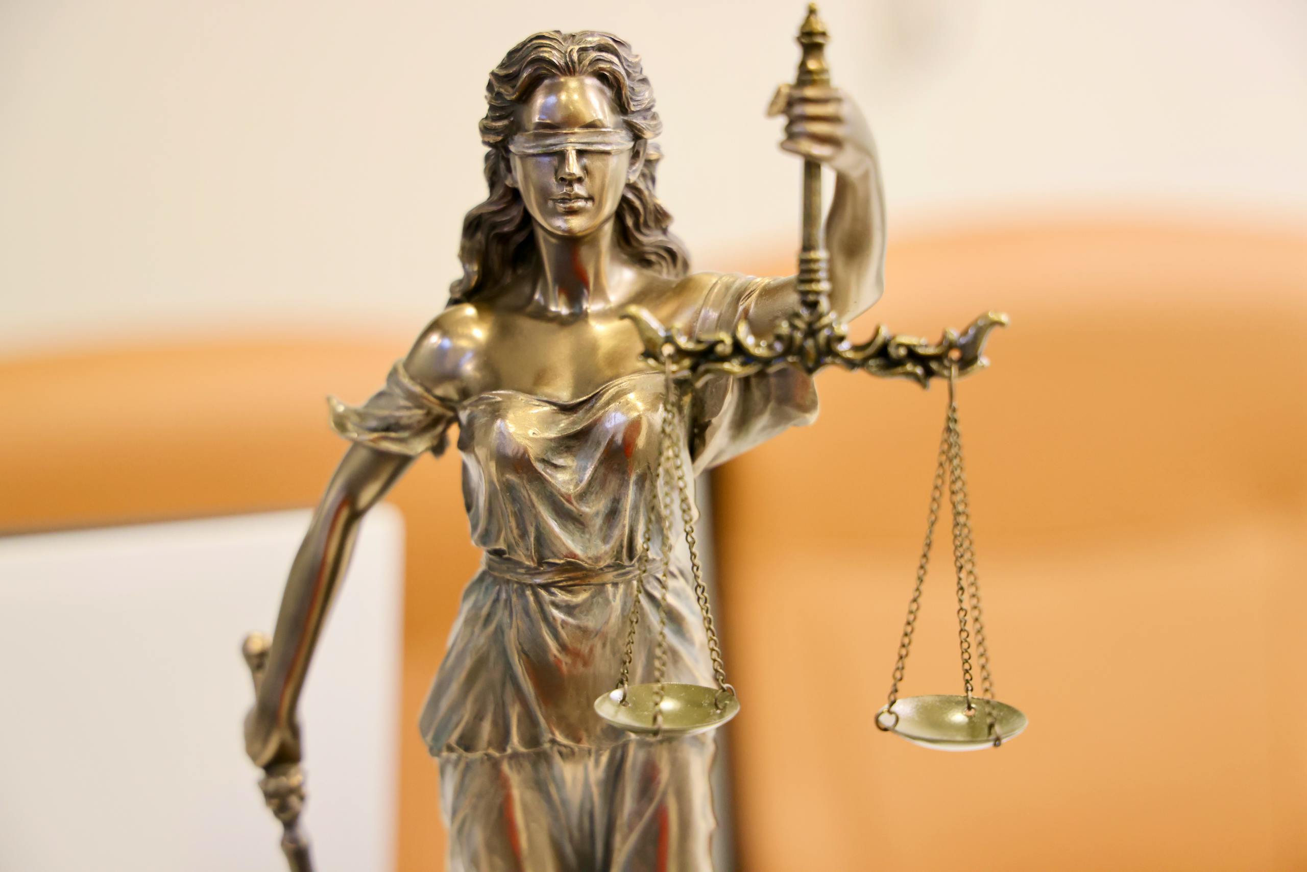 Detailed image of Lady Justice statue, symbolizing fairness and impartiality.