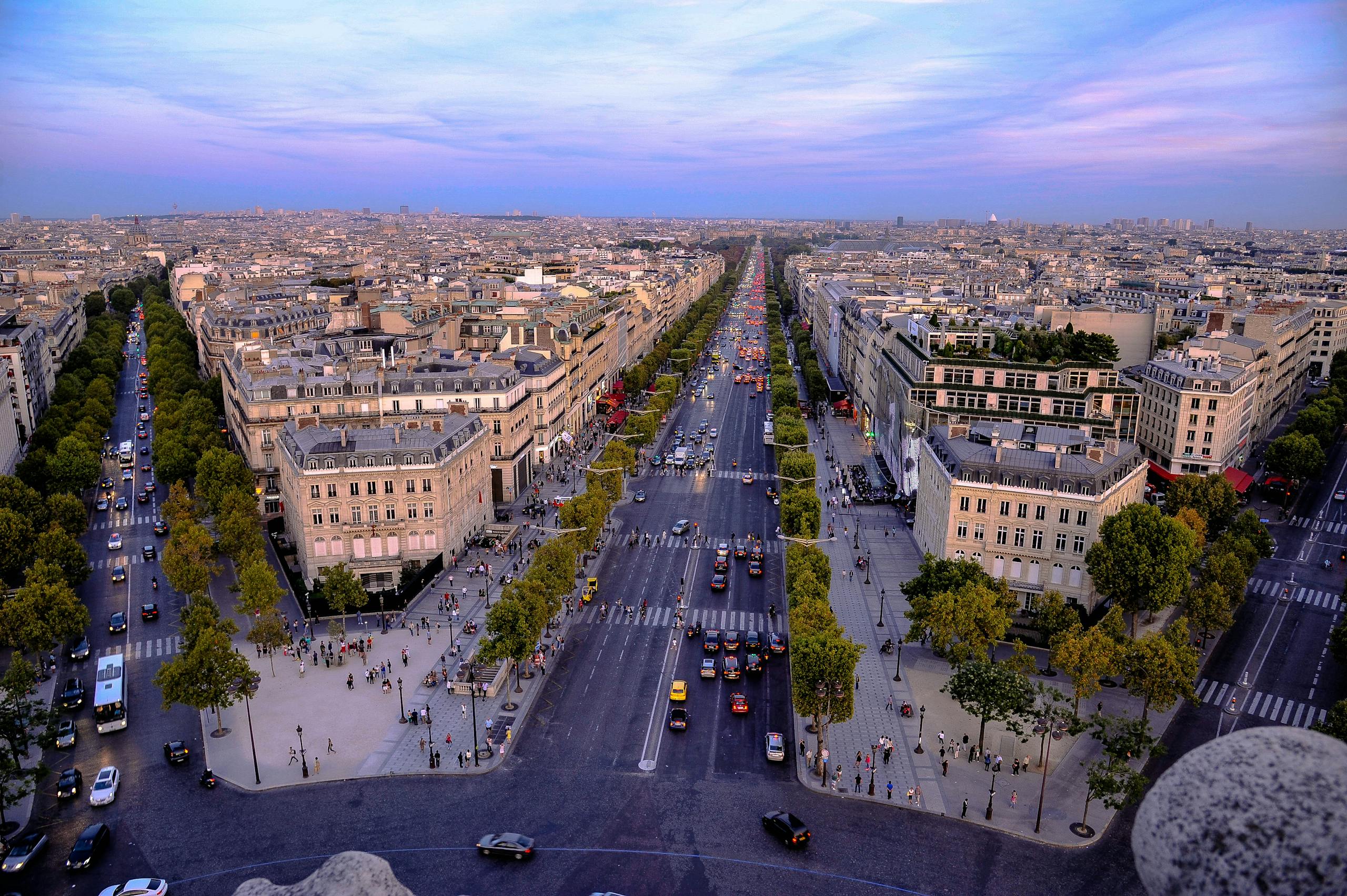 Stunning aerial photo of Paris showcasing the historic Champs-Élysées at dusk.