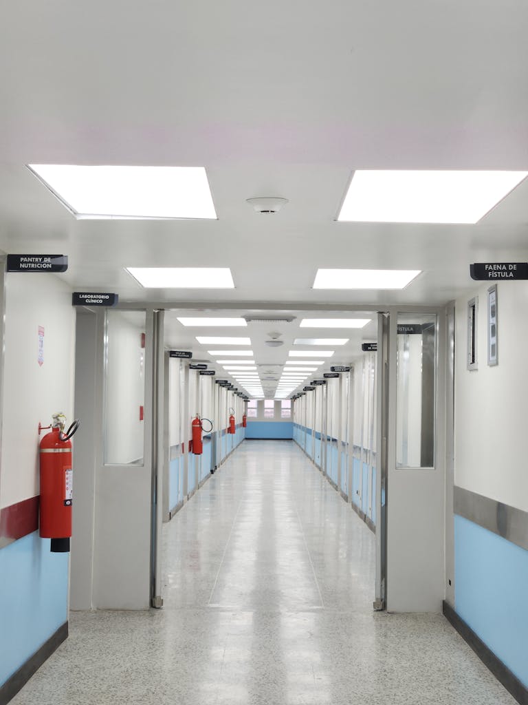 Well-lit hospital corridor with fire extinguishers in Maracaibo, Venezuela.